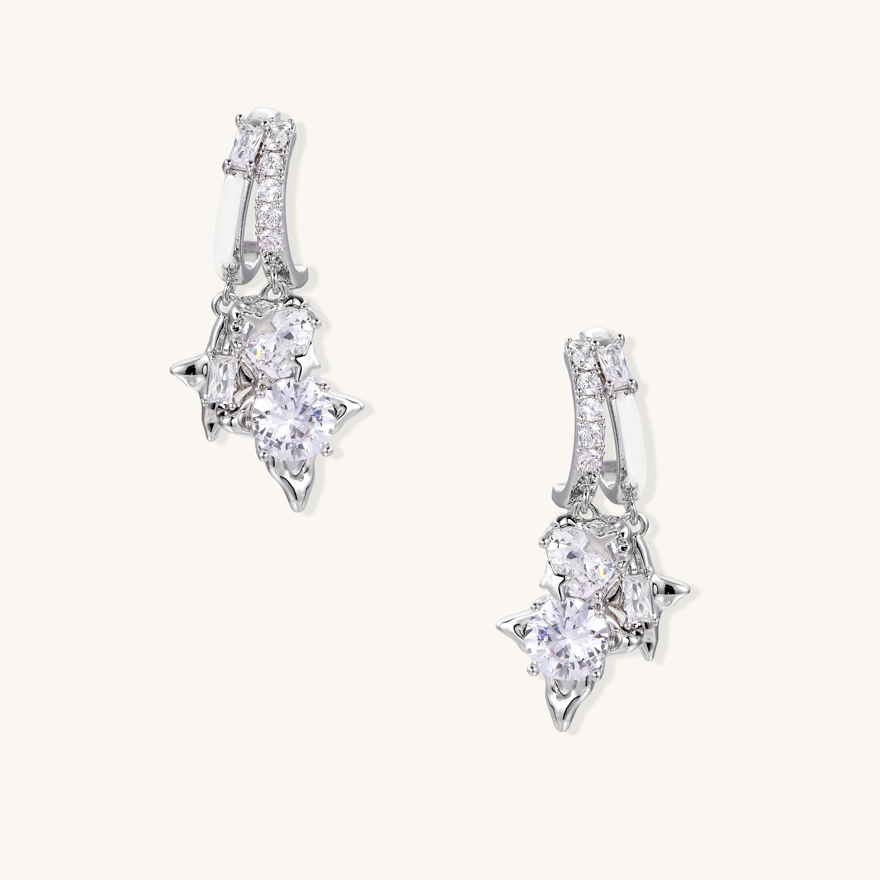Pair of gold-plated drop earrings featuring cascading zirconia crystals in geometric cluster design on neutral background