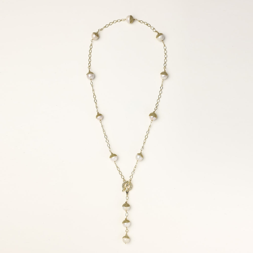 Long gold-plated lariat necklace featuring baroque pearls with metal caps arranged in elegant Y-shape design