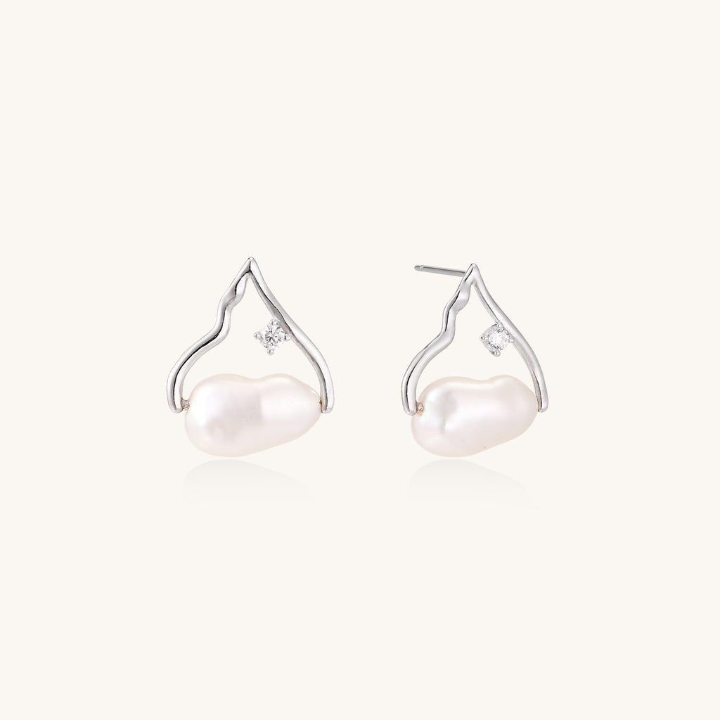 Sterling silver teardrop-shaped stud earrings with white freshwater pearls nestled in elegant flame-like frames