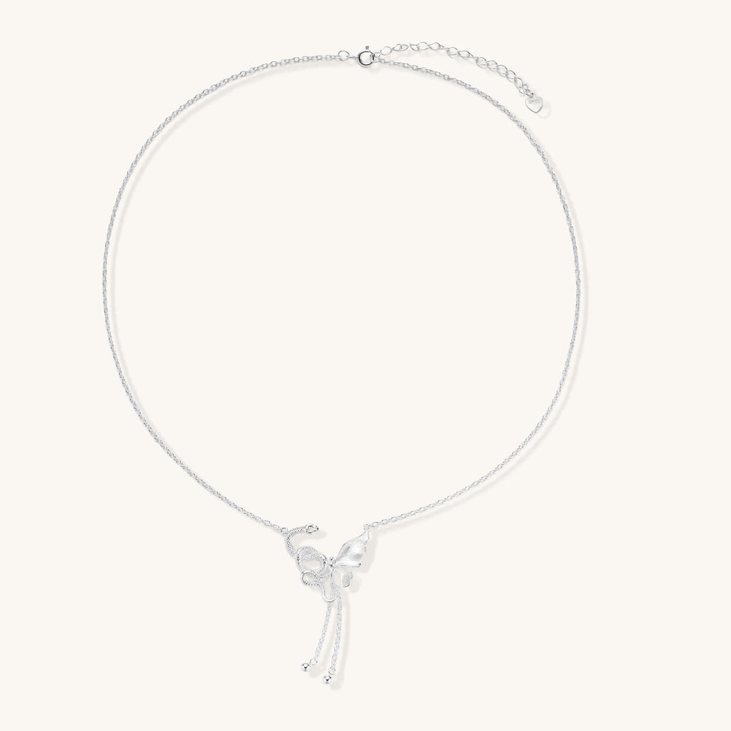 Delicate sterling silver butterfly pendant necklace with textured wing details and adjustable chain on white background