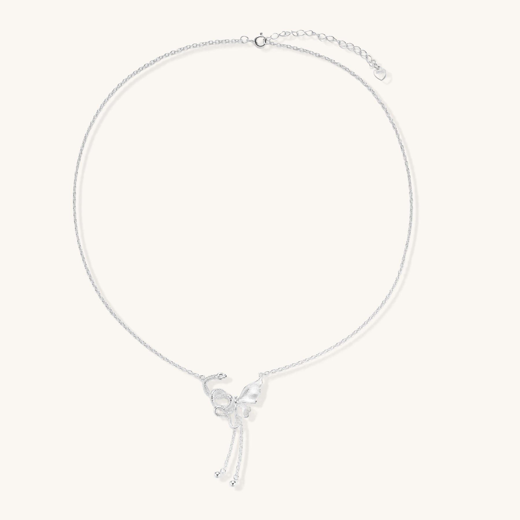 Delicate sterling silver butterfly pendant necklace with textured wing details and adjustable chain on white background