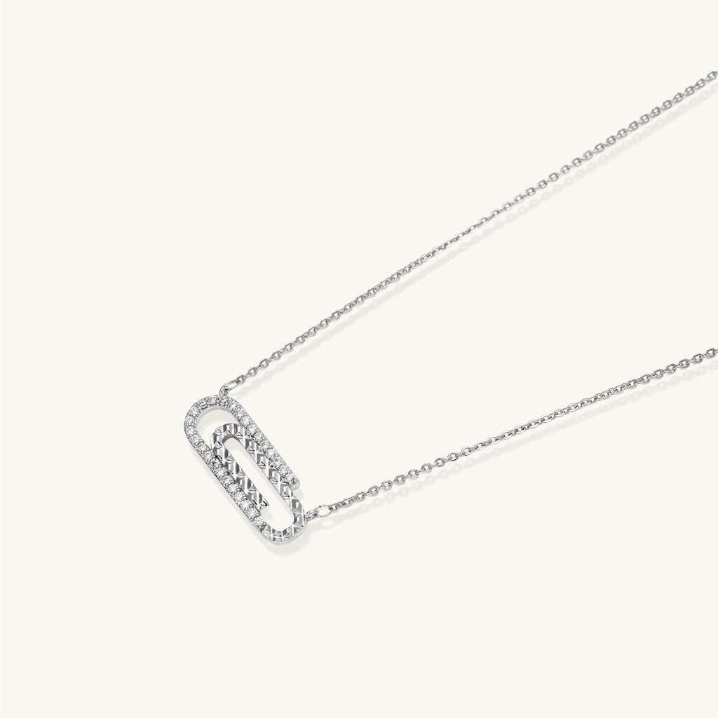 Delicate 14K gold plated chain necklace with crystal-accented carabiner-style pendant on white background