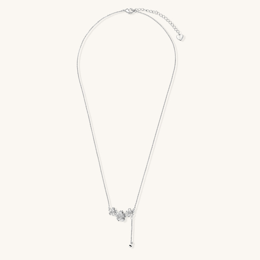 Delicate Y-style necklace with three textured flower pendants and adjustable chain in 14K gold plated brass finish.