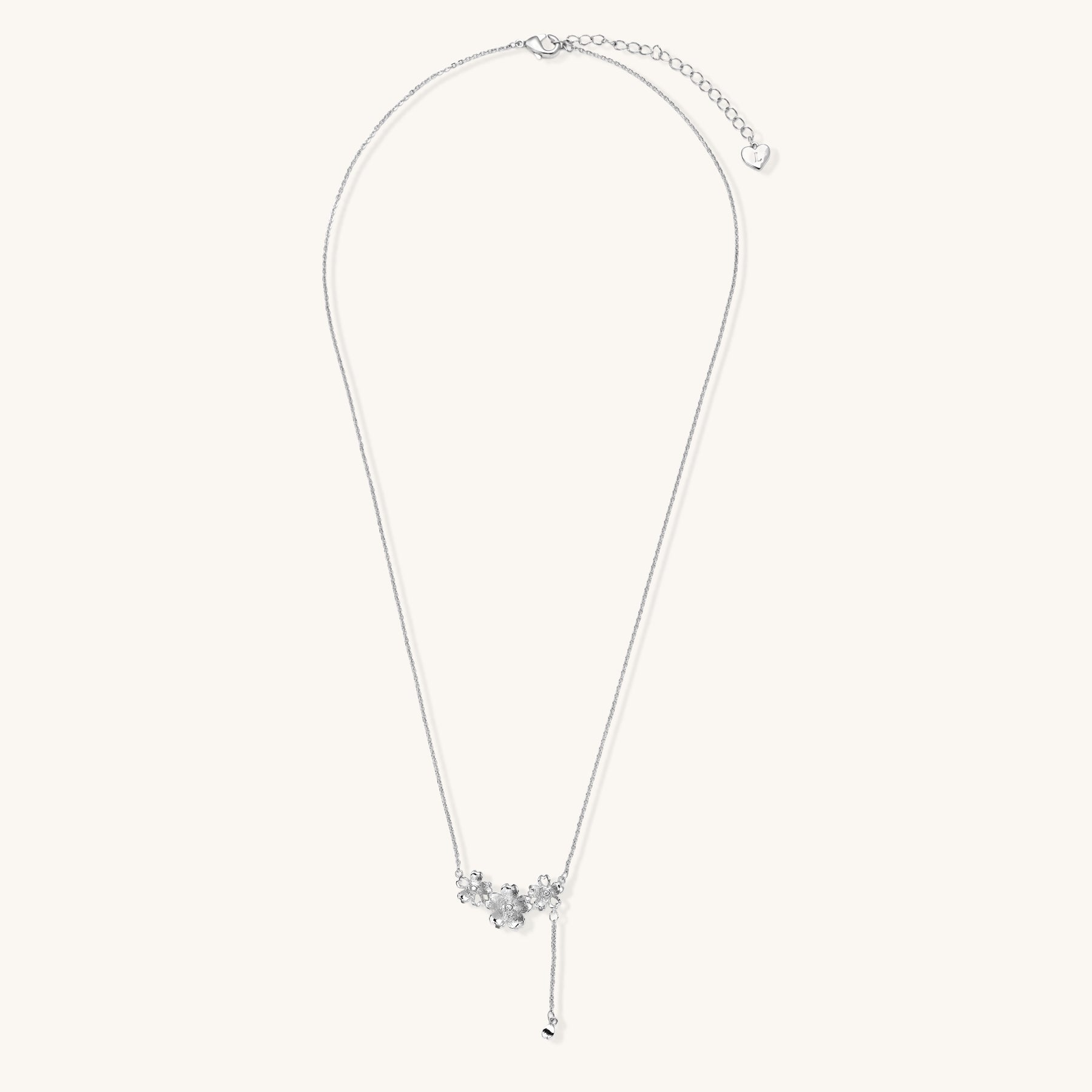 Delicate Y-style necklace with three textured flower pendants and adjustable chain in 14K gold plated brass finish.