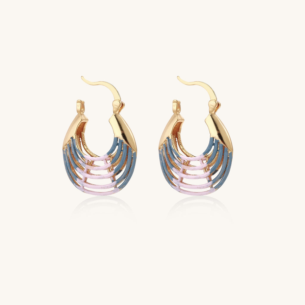 Gold hoop earrings with layered blue to pink enamel in shell pattern, photographed against white background