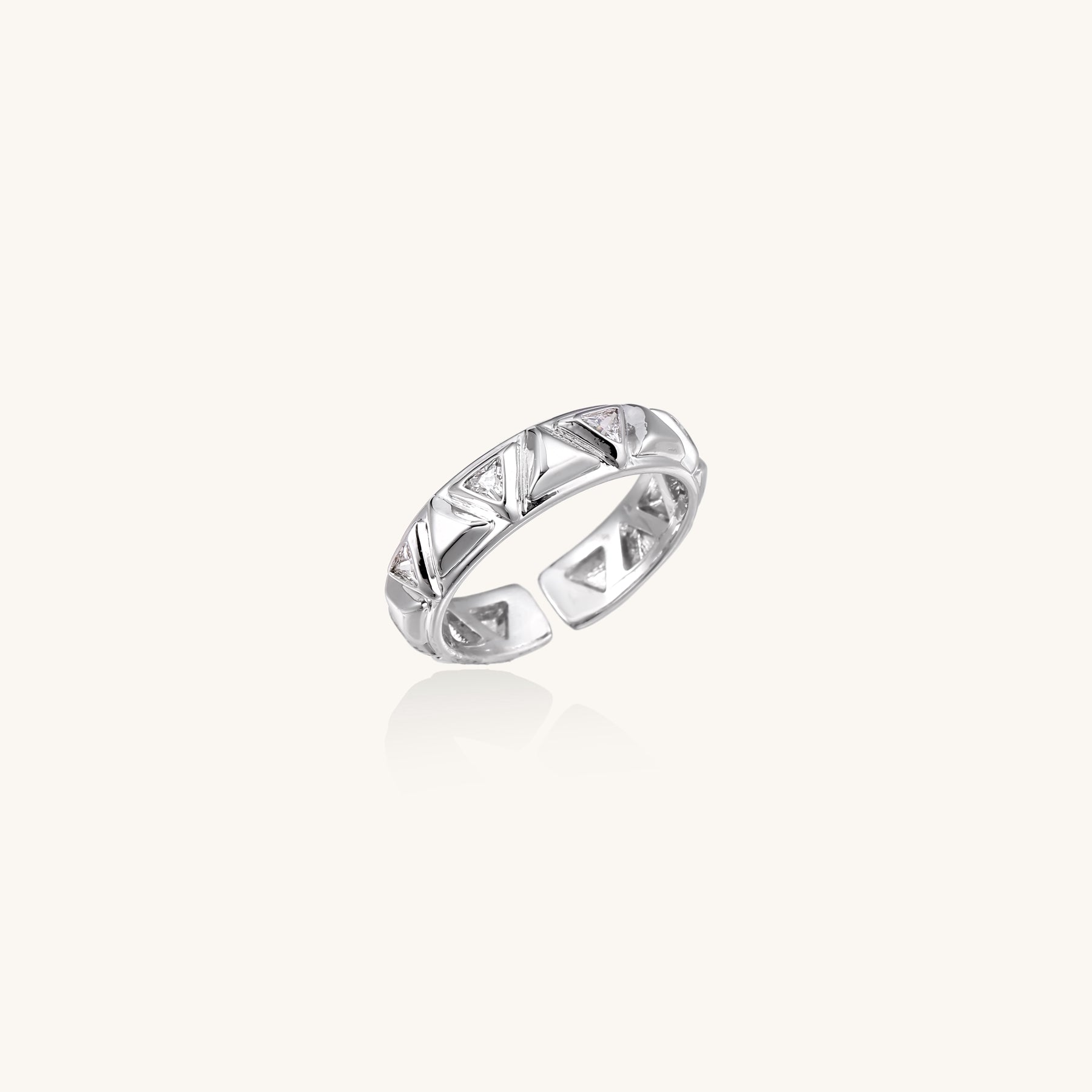 18K gold plated adjustable ring with triangular cutout pattern and sparkling zirconia stones on white background.