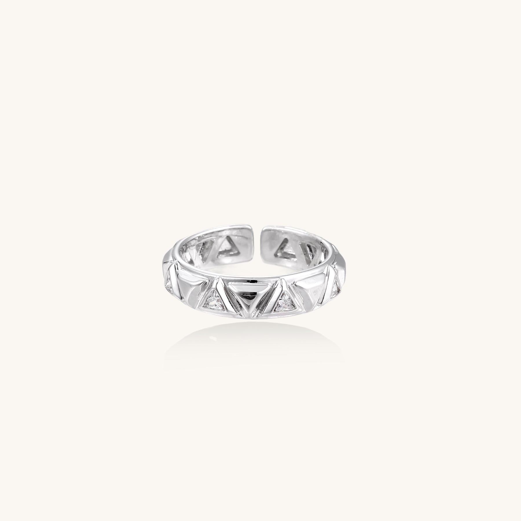 18K gold plated adjustable ring with triangular cutout pattern and sparkling zirconia stones on white background.