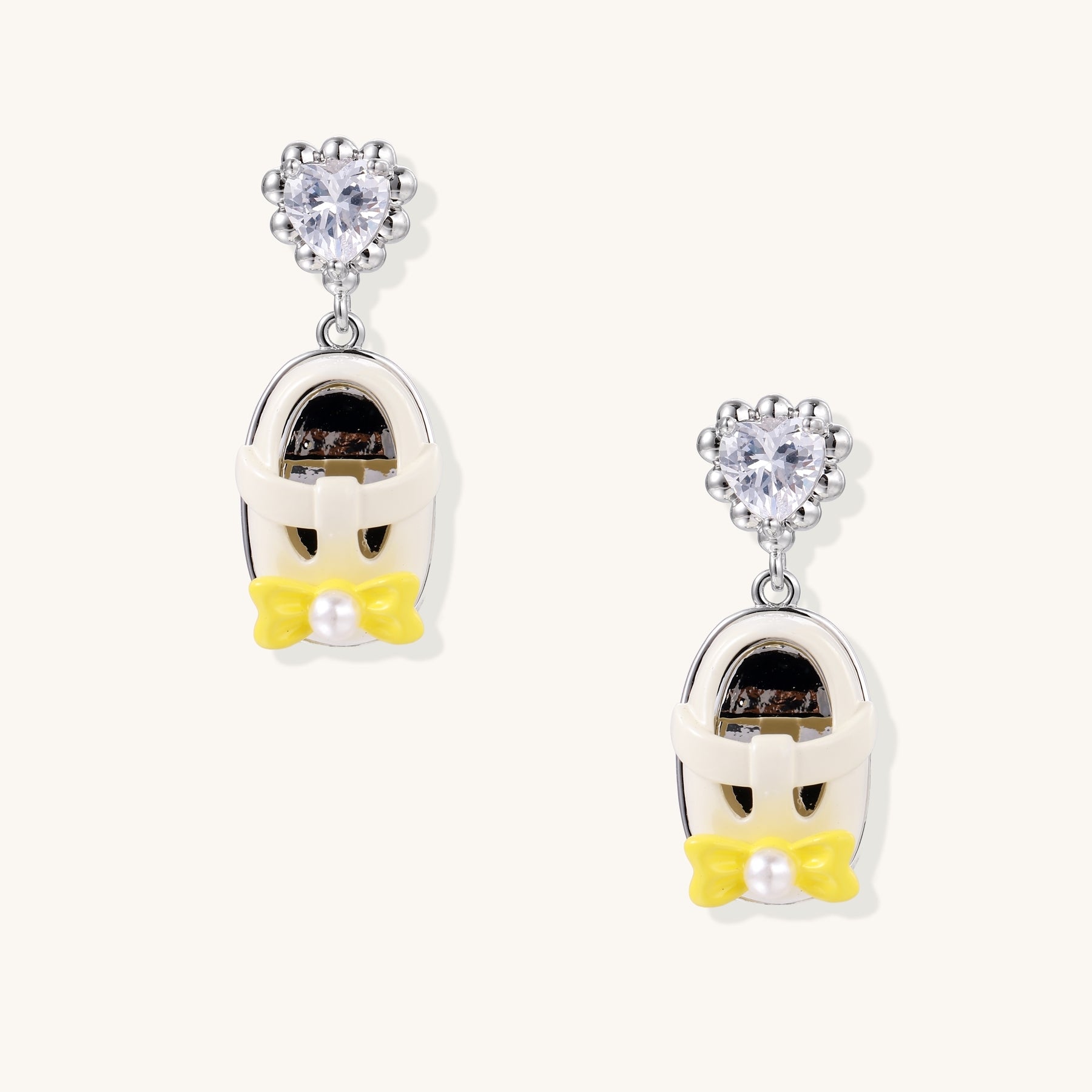 18K gold plated drop earrings with heart-shaped zirconia studs and translucent mini handbag pendants with pearl accents