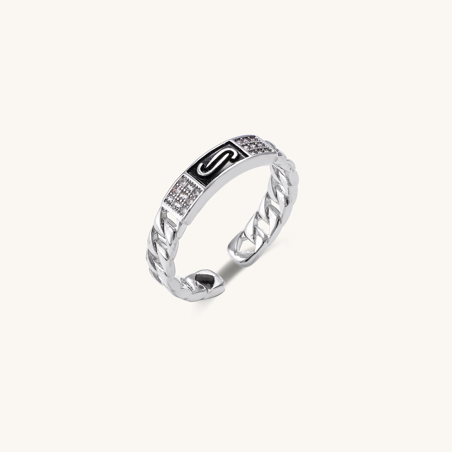 Two gold-plated rings with chain-link bands, one featuring cubic zirconia halo setting, displayed on neutral background