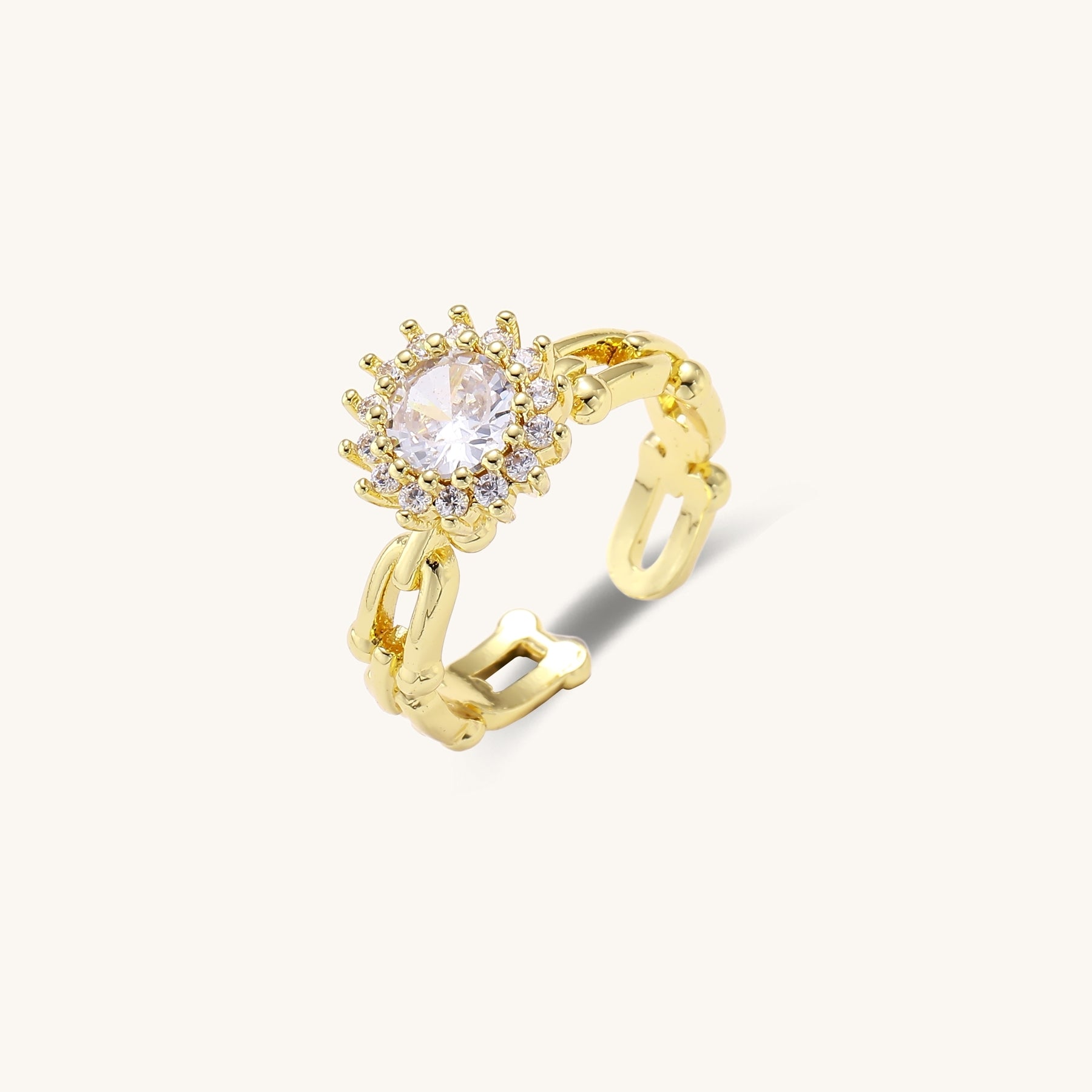 Two gold-plated rings with cubic zirconia halo design and chain-link band on white background, adjustable sizing.