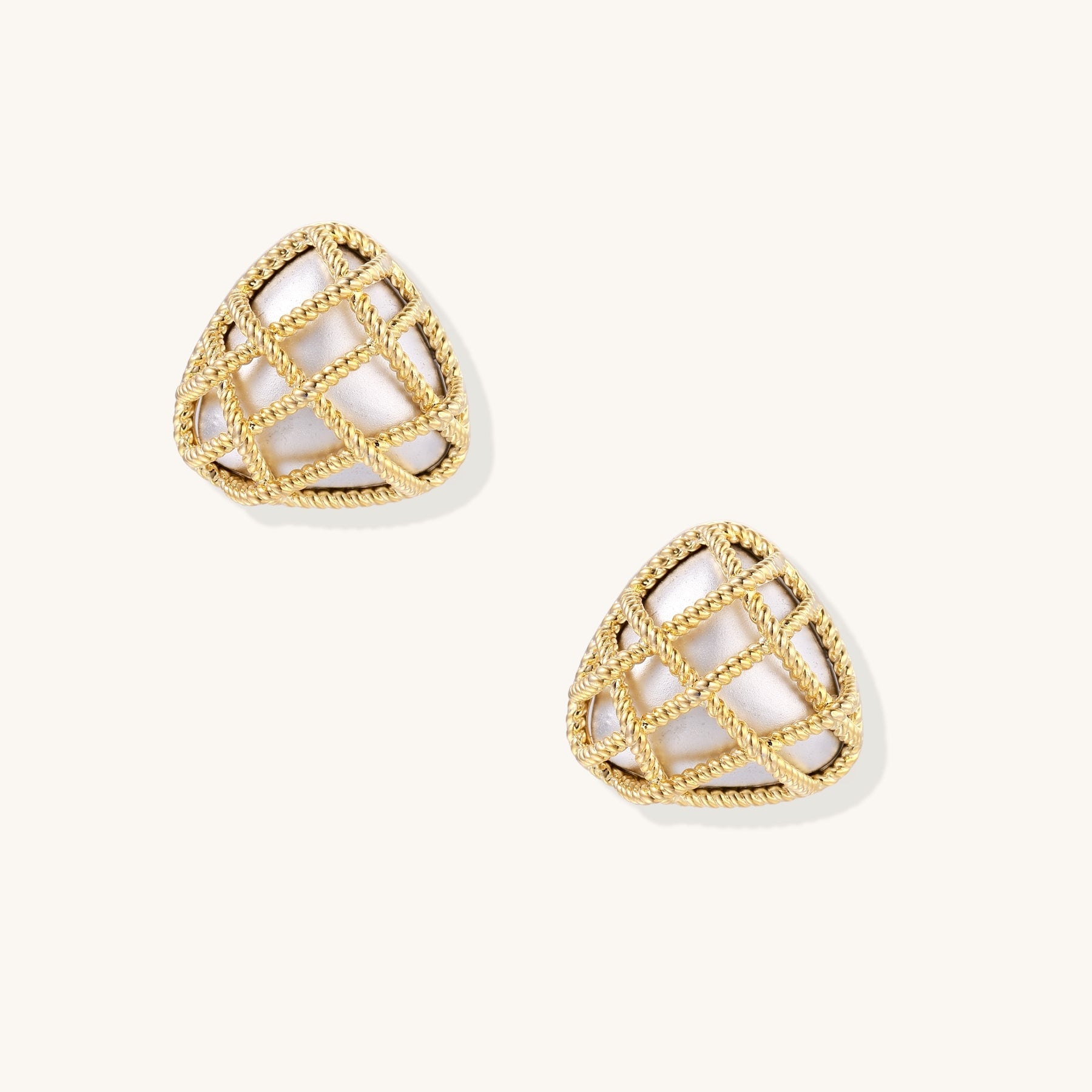 Pair of geometric gold-plated stud earrings with twisted rope lattice pattern and openwork design on white background.