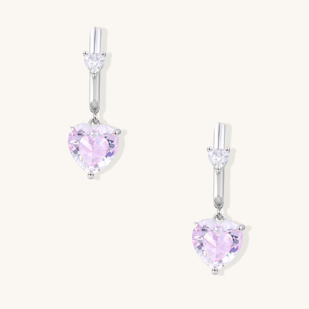 Elegant drop earrings featuring pink heart-shaped zirconia stones with clear accent gems in gold-plated settings