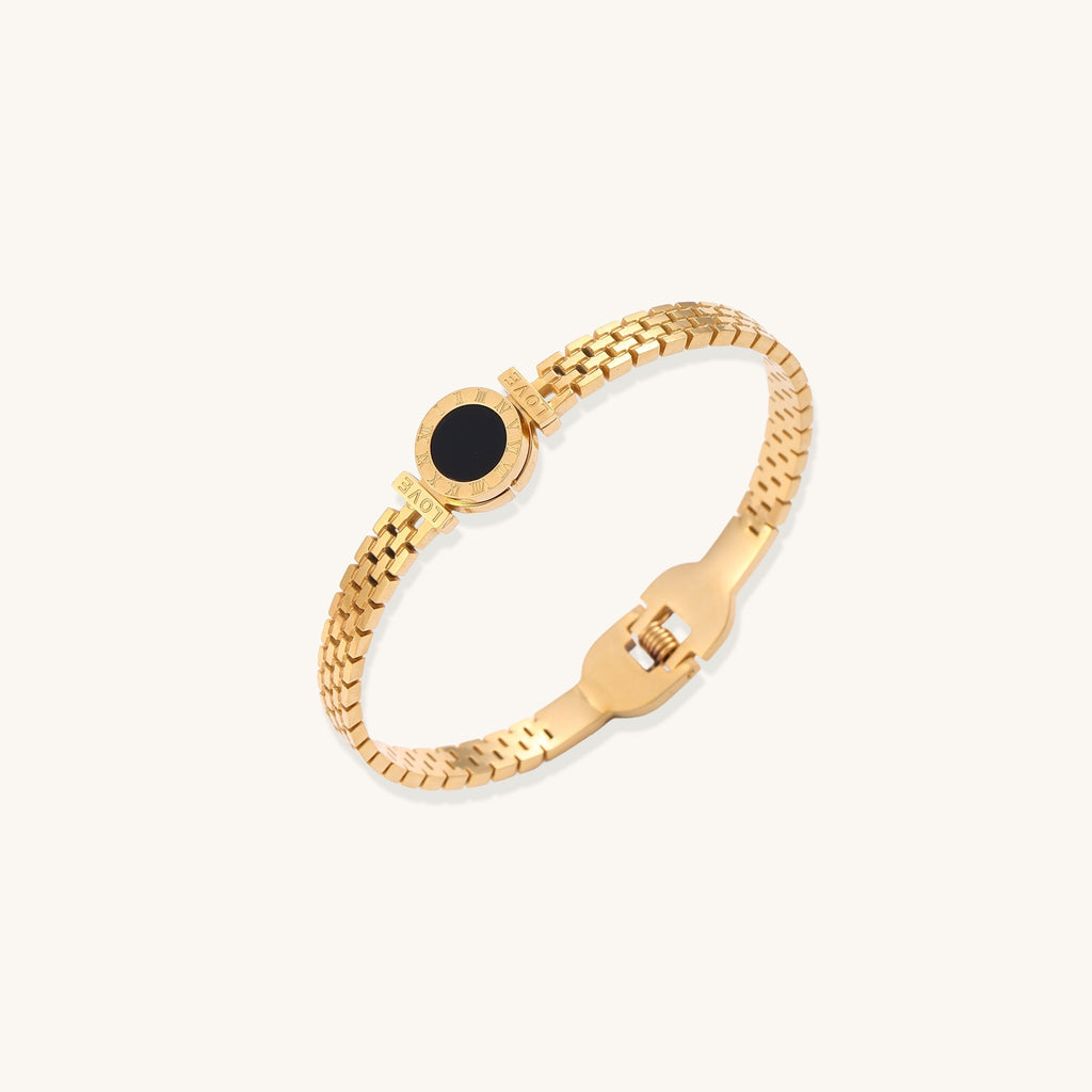 Gold mesh chain bracelet with black mother of pearl centerpiece in circular setting, showing delicate woven pattern