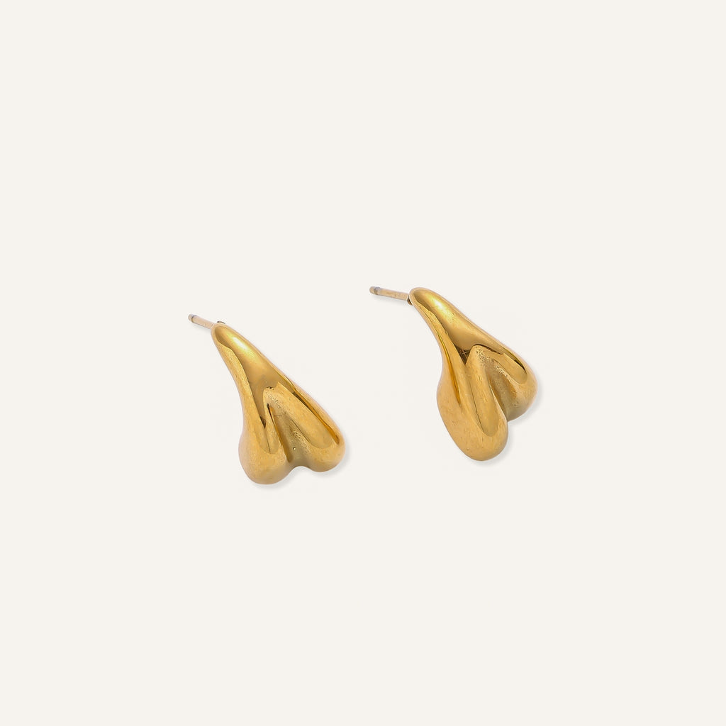 Pair of gold-plated sculptural stud earrings with organic teardrop shapes on neutral background.